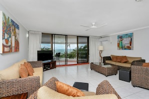 Superior Three Bedroom Sea View Apartment | Living area | 42-inch flat-screen TV with cable channels, LCD TV, DVD player - Roydon Beachfront Apartments (Trinity Beach)