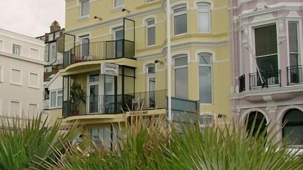 A multi-story building with a sign indicating it is a hotel. - Grand Hastings (St Leonards-On-Sea)