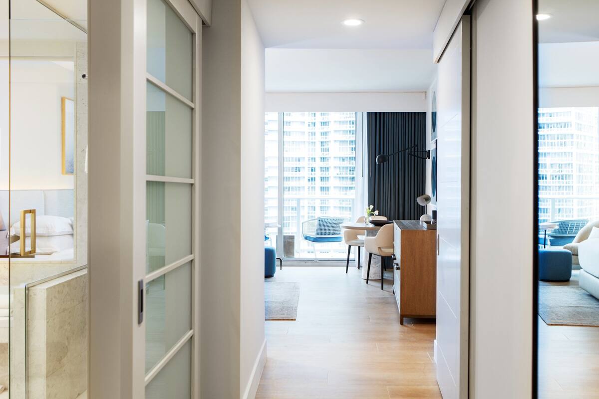 A modern interior with a dining area, kitchen, and living space.