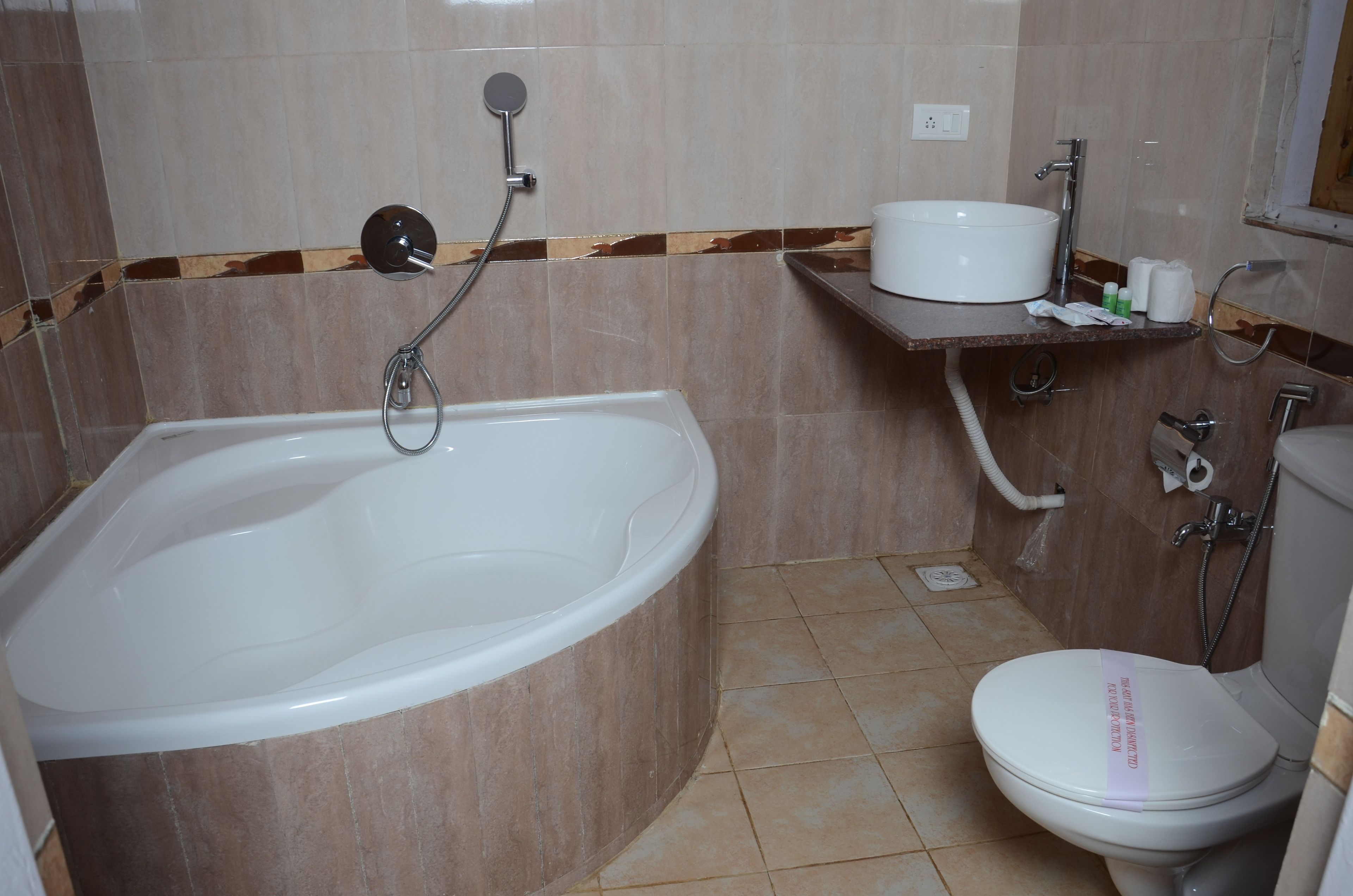 A bathroom with a bathtub, sink, toilet, and shower.