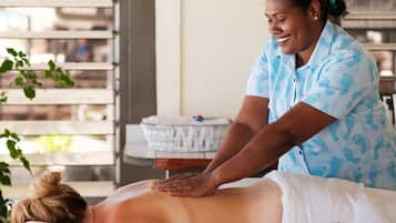 Experience a tranquil massage therapy session in a serene room with a large window and a comfortable massage table.
