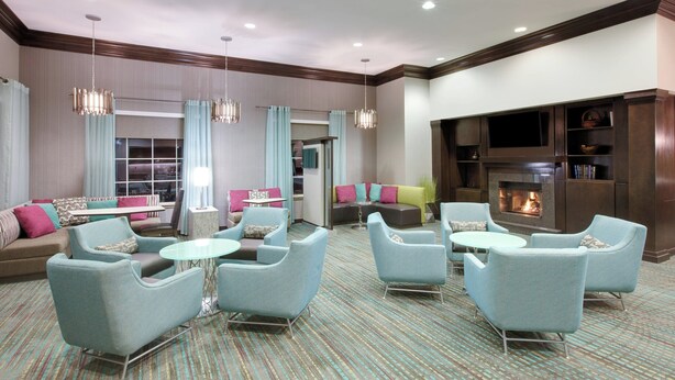 A spacious lounge area with comfortable seating, a fireplace, and a television. - Residence Inn by Marriott Midland (Midland)