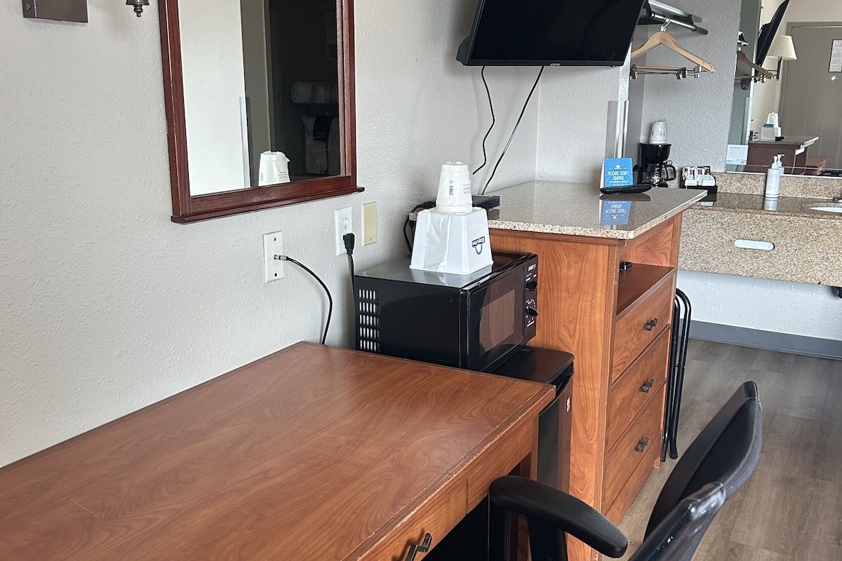 Desk, laptop workspace, blackout drapes, iron/ironing board