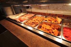 A buffet with various food items including sausages, fries, and other snacks. - The Craig-Y-Don Hotel (Blackpool)