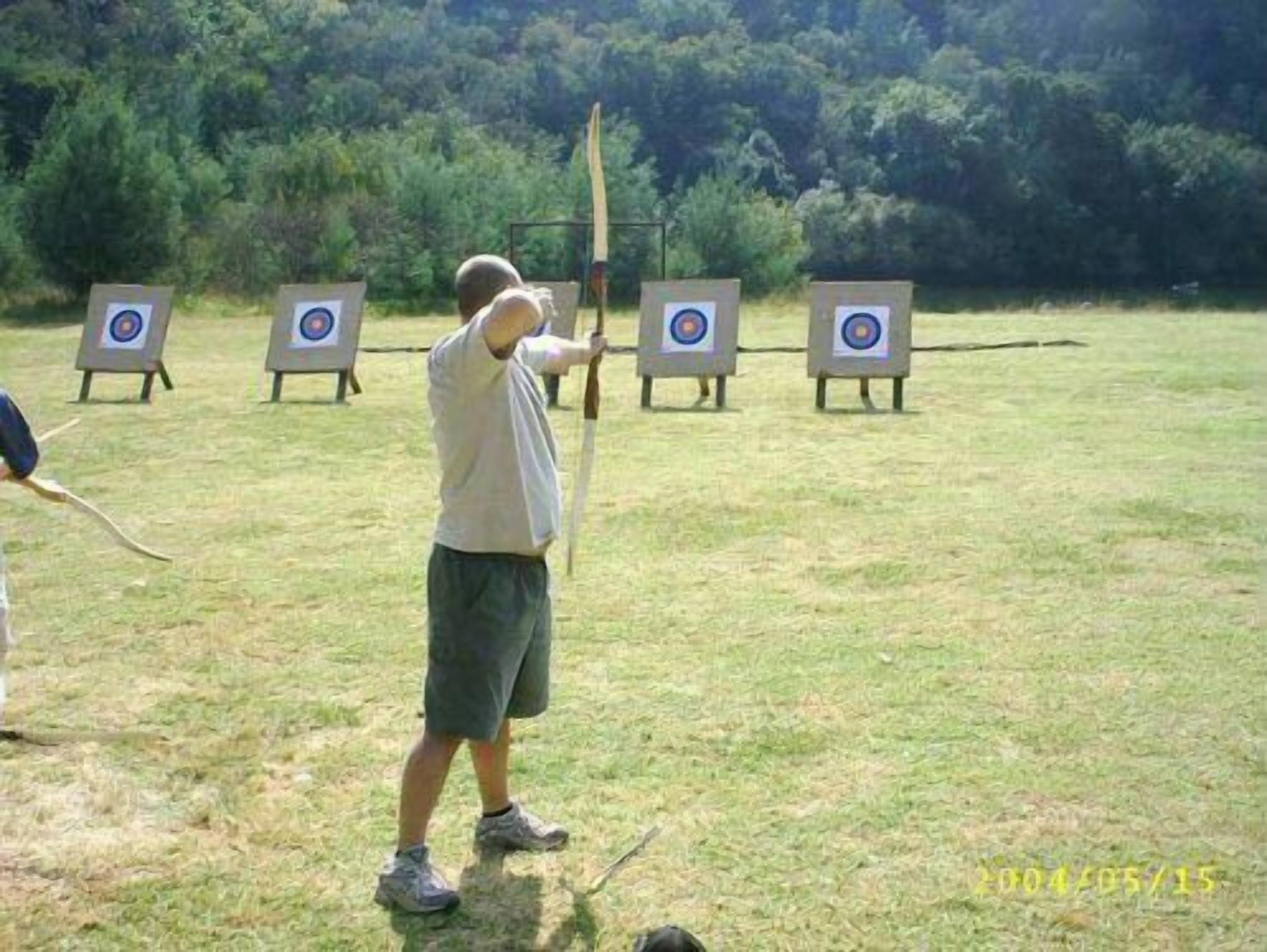 An outdoor archery range with multiple targets.