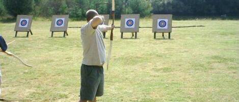 An outdoor archery range with multiple targets.