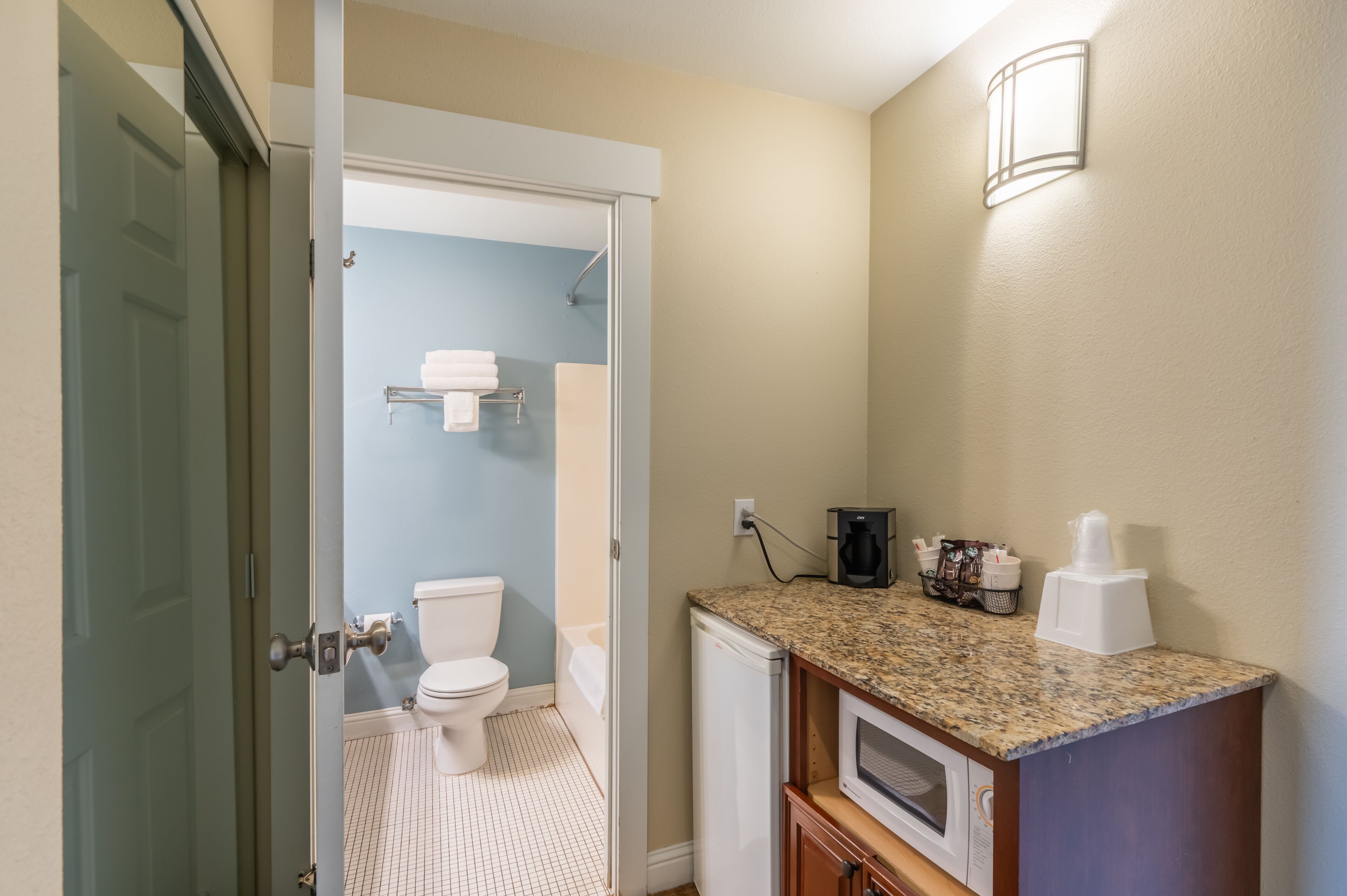 A bathroom with a toilet, sink, and shower.