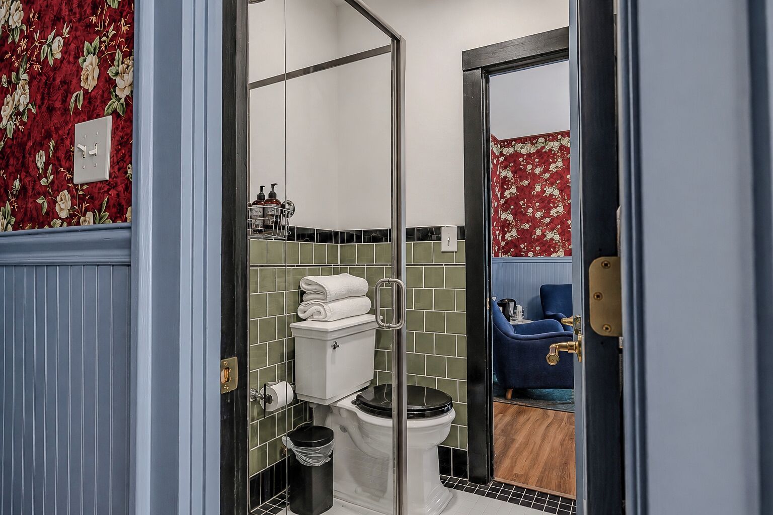 A bathroom with a toilet, a sink, and a shower area.