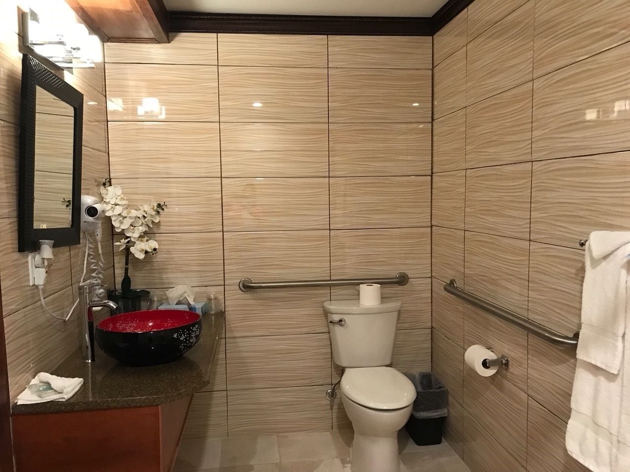 A modern bathroom with a vanity, sink, and toilet.