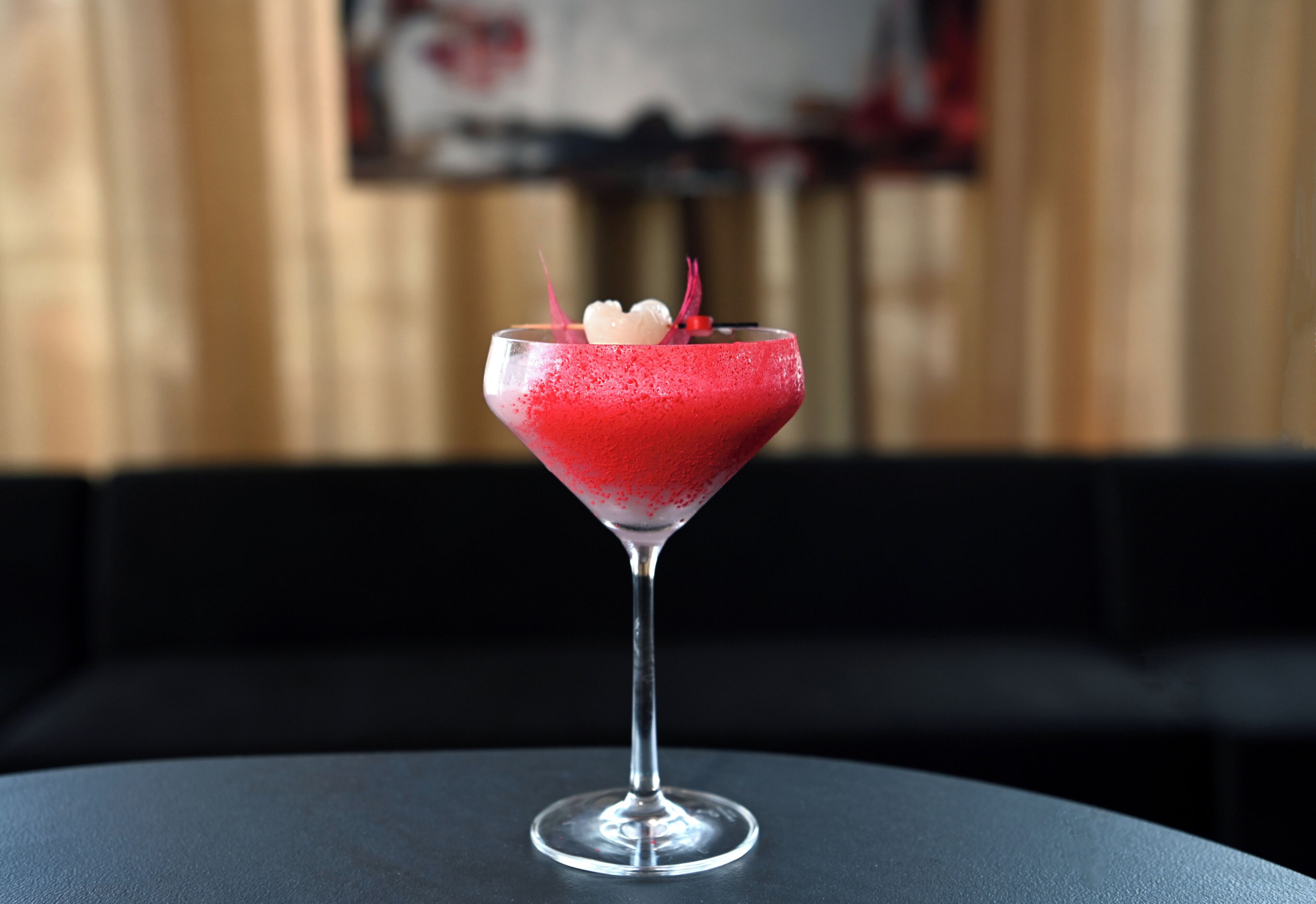 Un cóctel en una copa de martini sobre una mesa.