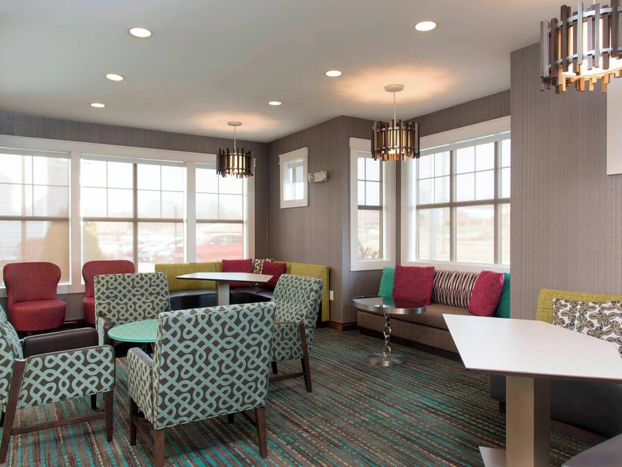 A modern lounge area with seating arrangements, including chairs and sofas, and a small table.