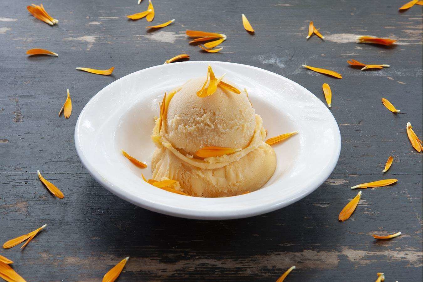 A white plate with a dessert on a dark wooden surface.