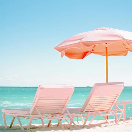 On the beach, white sand, beach cabanas, sun loungers
