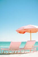 On the beach, white sand, beach cabanas, sun loungers