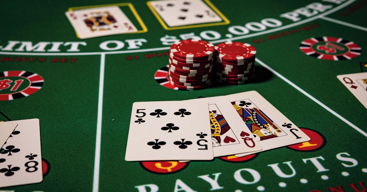 A casino table with playing cards and poker chips.