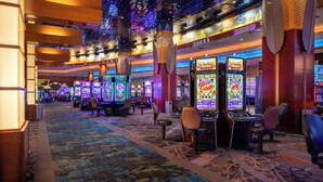 A casino floor with slot machines, gaming tables, and a carpeted walkway. - Seneca Allegany Resort & Casino (Salamanca)