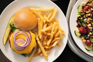 A plate with a burger, fries, and a salad.