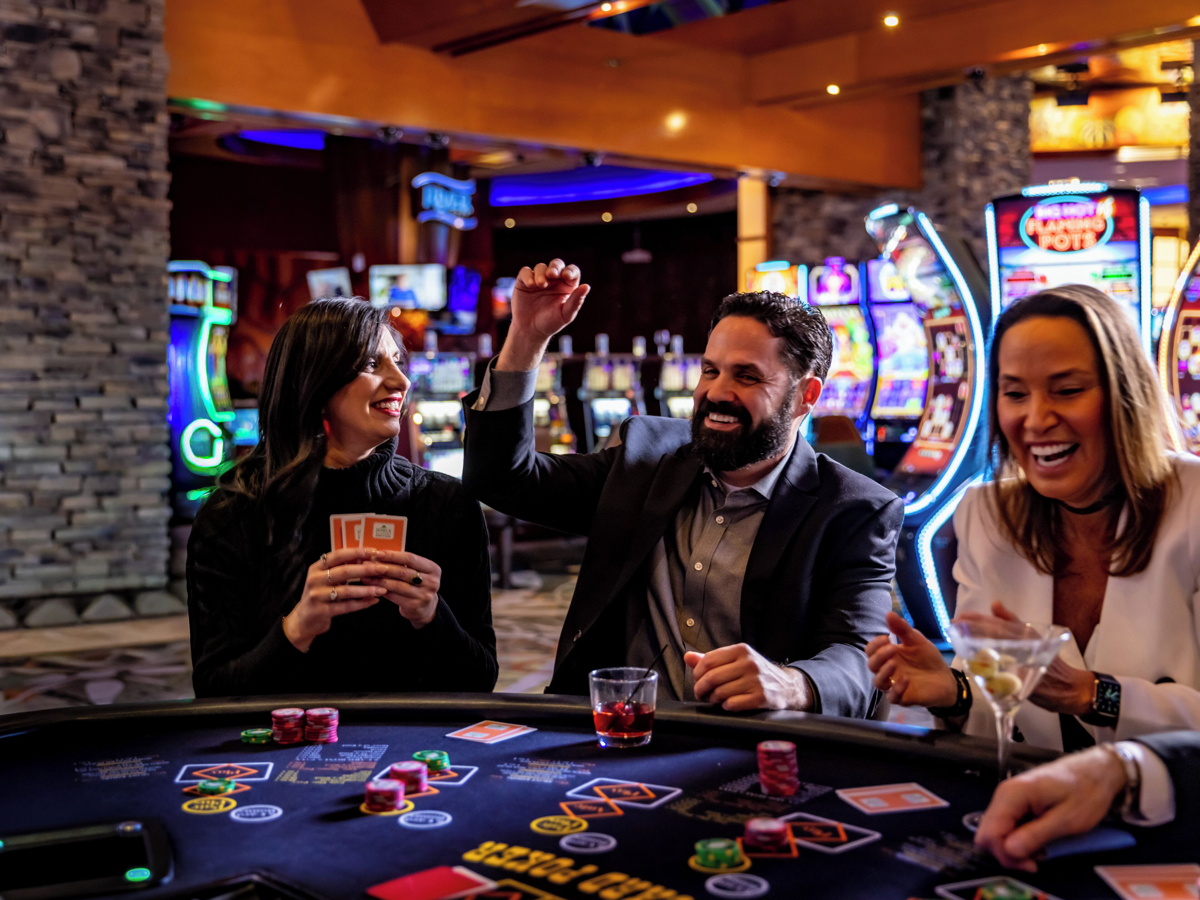 A casino setting with gaming tables, chips, and a martini glass.