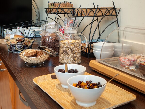 A breakfast buffet with various food items and containers.