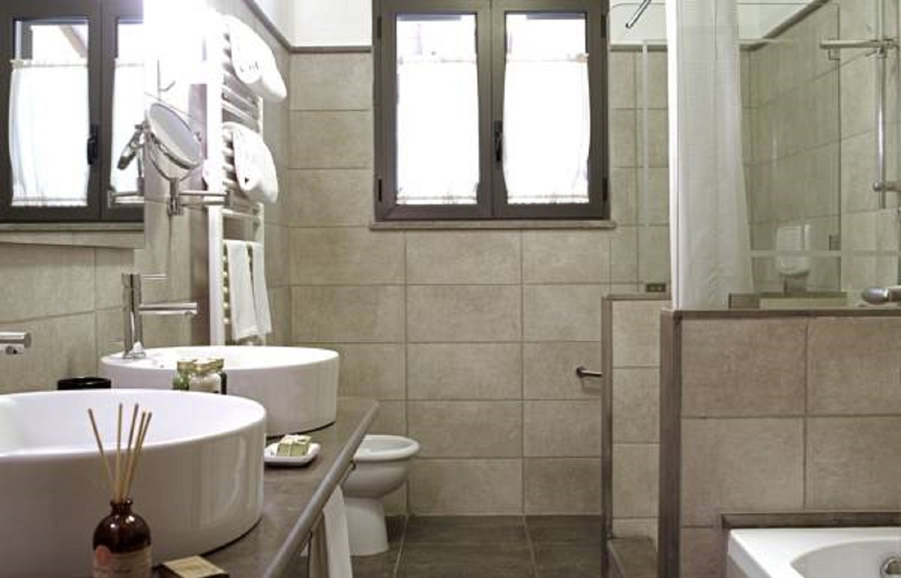 A modern bathroom with a large bathtub, a toilet, and a shower area.