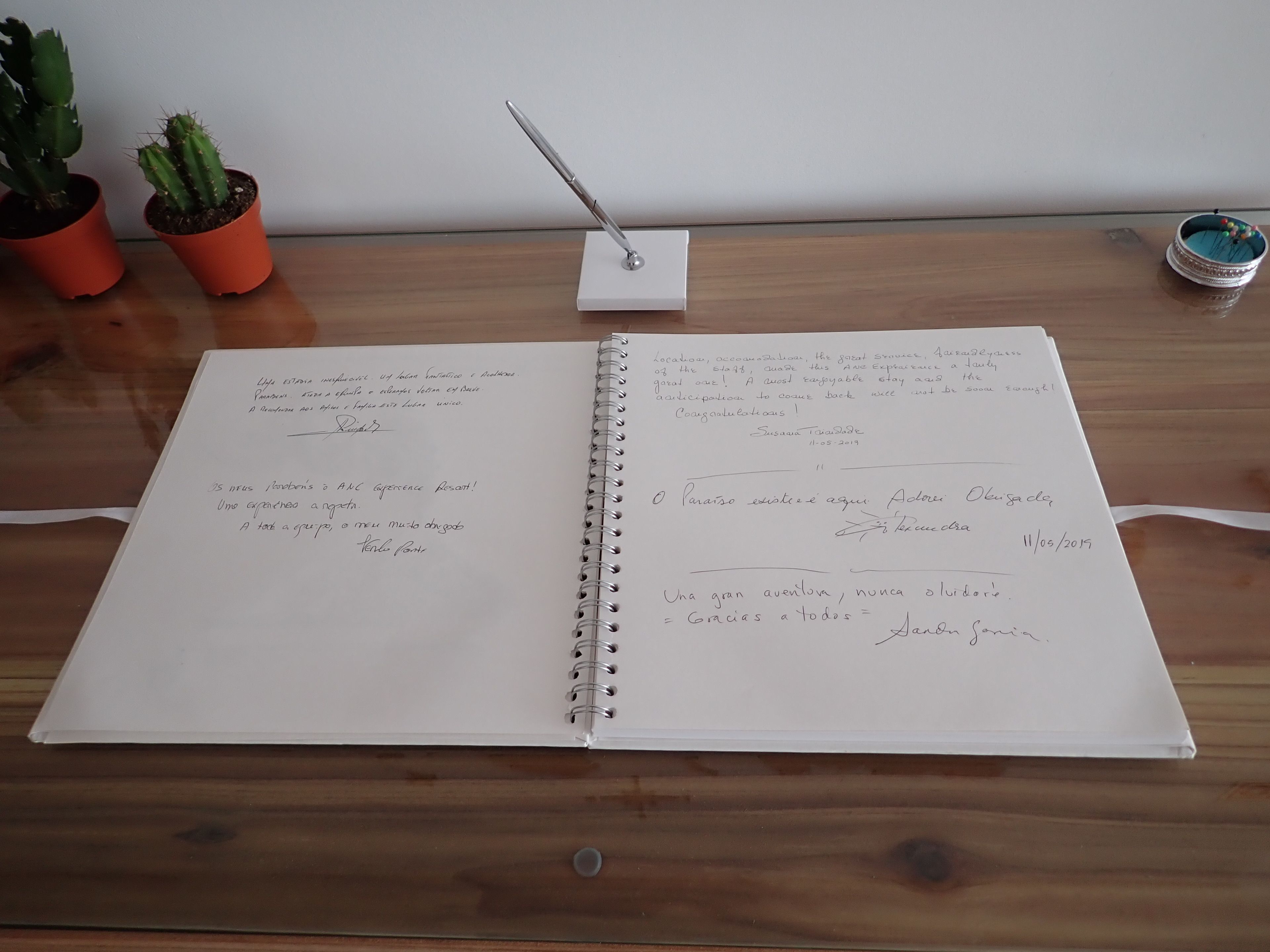 An open notebook with handwritten notes on a wooden table.