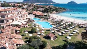 Un complexe hôtelier doté d’une piscine, d’une plage et offrant une vue sur les montagnes.