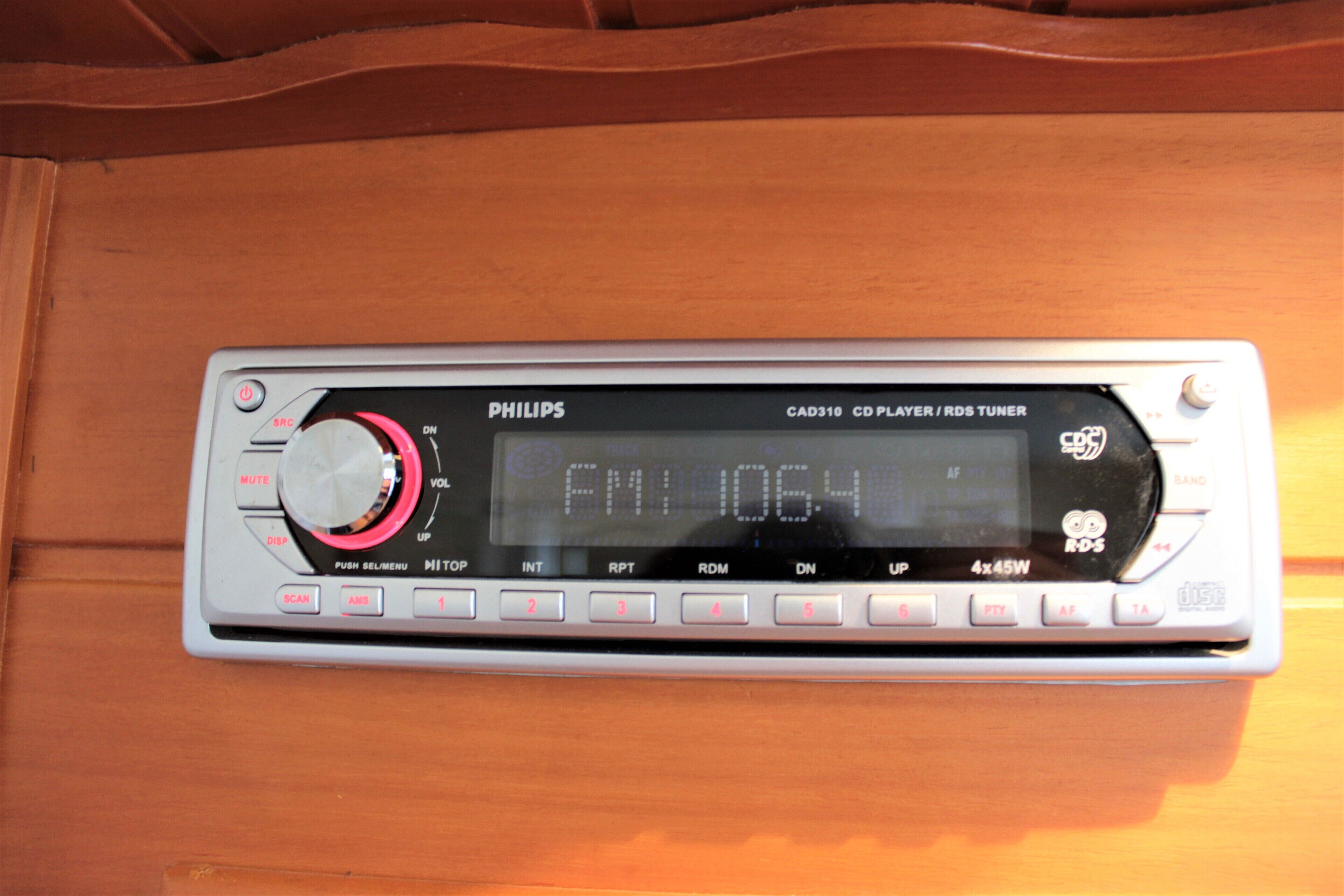 A Philips CD player with a display screen, control buttons, and a volume knob.