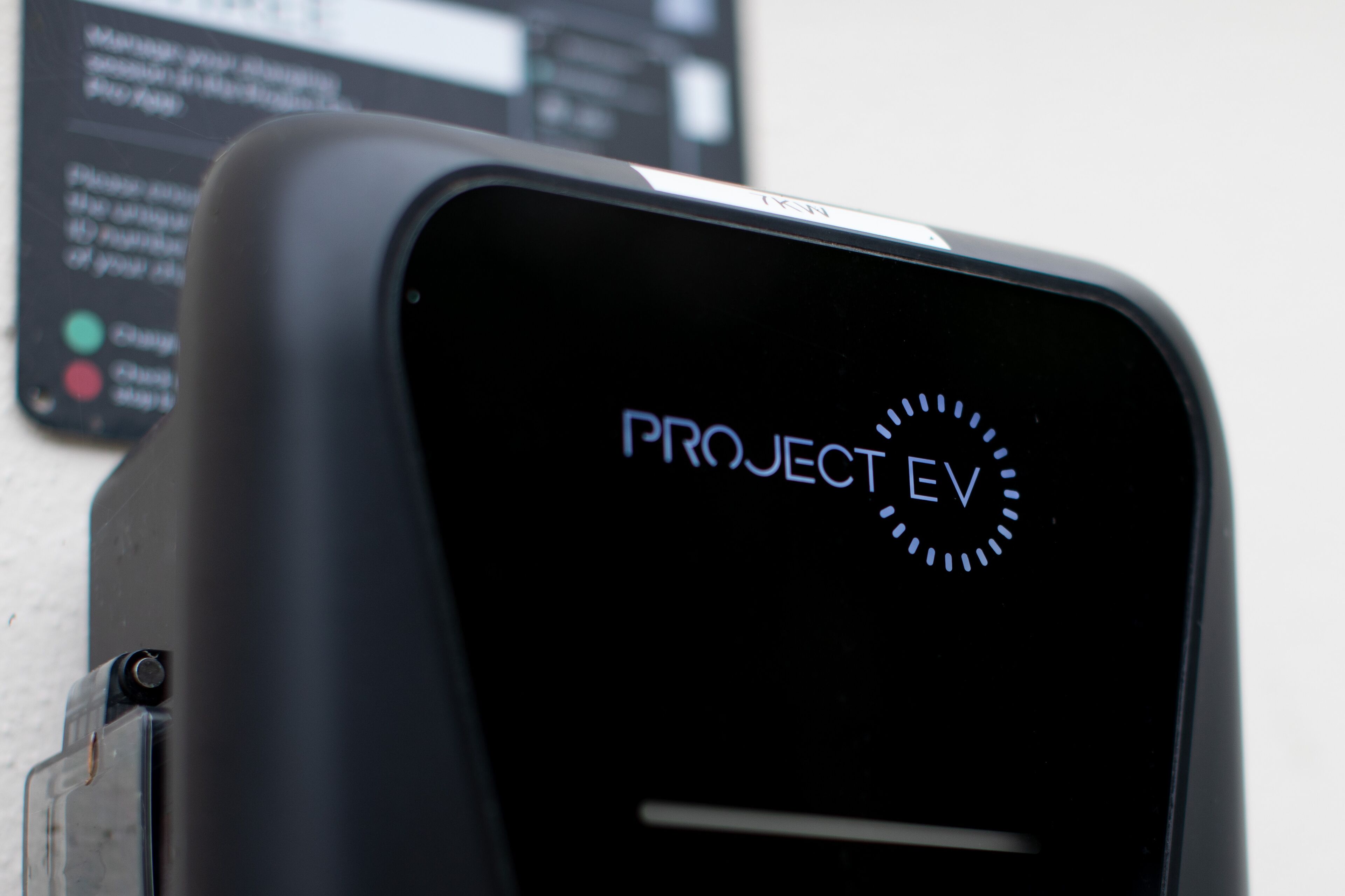 A black electronic device with the text "PROJECT EV" on its screen.