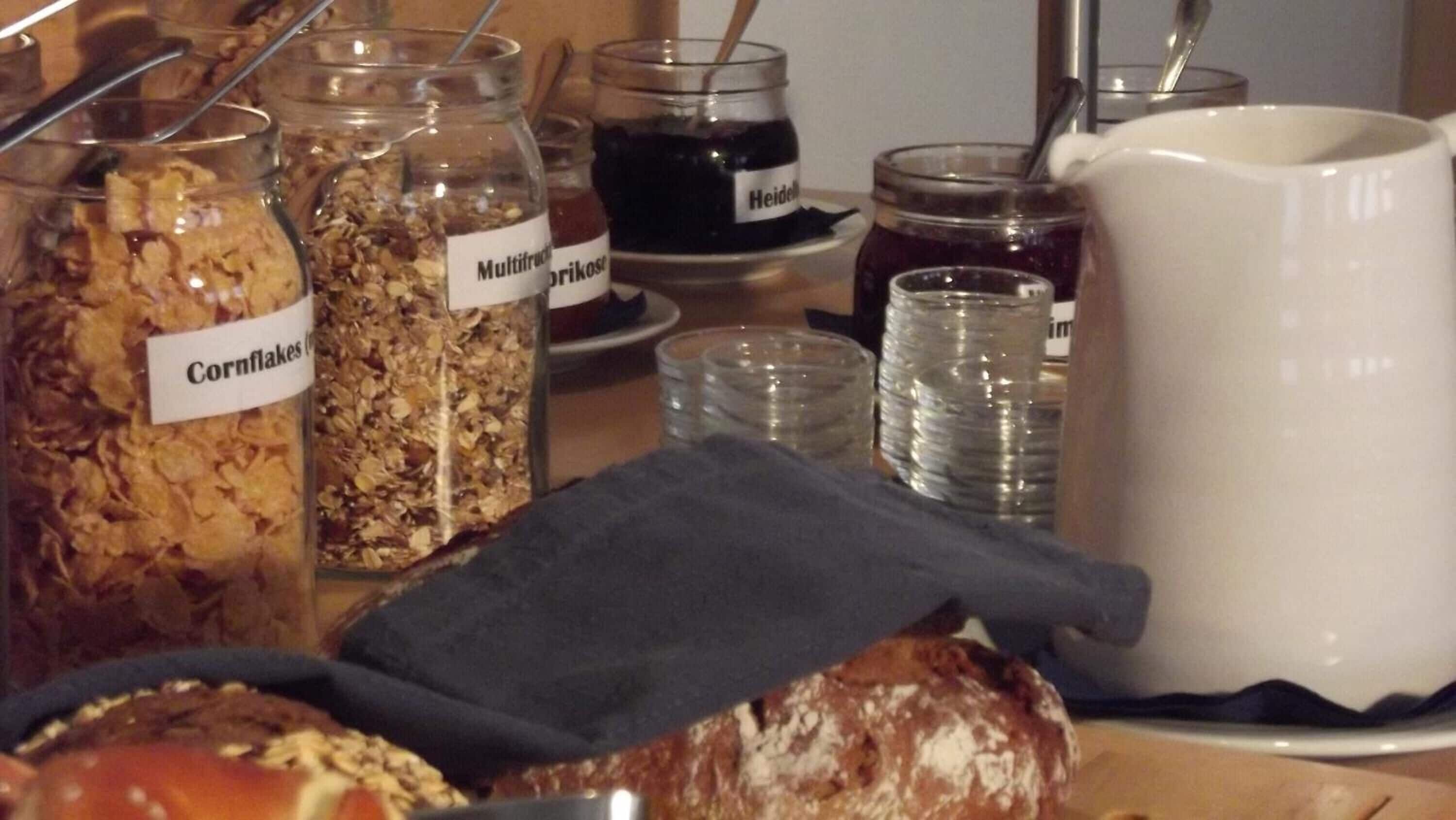 A breakfast buffet with various food items and condiments.