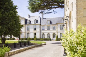 A large, historic building with multiple windows and a symmetrical facade.