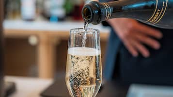 A bottle of champagne being poured into a glass.