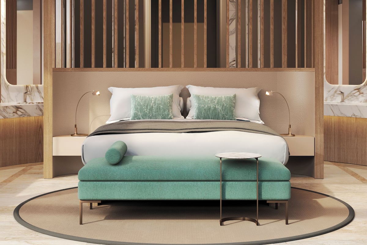 A modern bedroom with a large bed, a circular ceiling light, and a wooden partition.