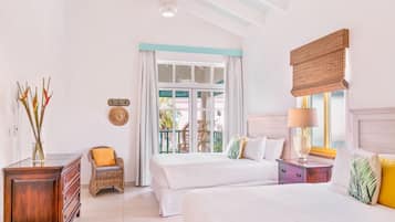 A bedroom with two beds, a dresser, a chair, and a window with curtains.