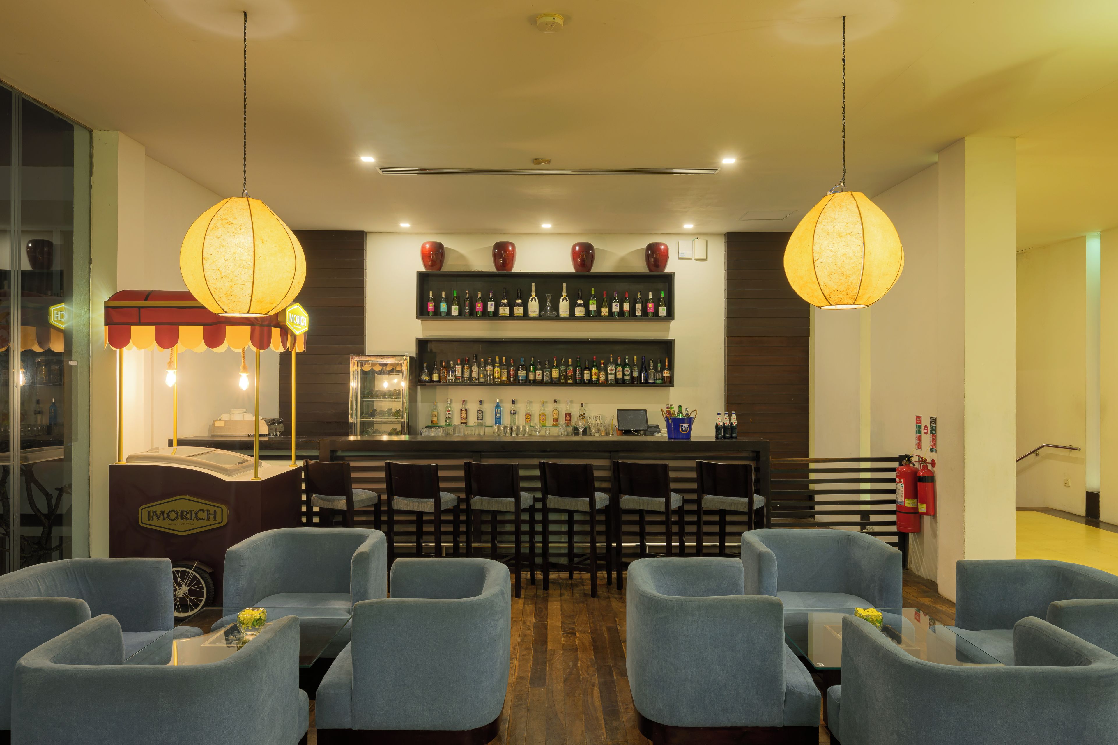 A bar area with seating and a display of liquor bottles.