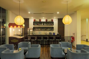 A bar area with seating and a display of liquor bottles.