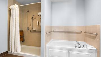 A bathroom with a shower, a bathtub, and a toilet.