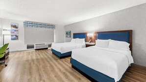 A hotel room with two beds, a desk, a chair, a radiator, and a wall-mounted artwork. - Hampton Inn Chattanooga - North/Ooltewah (Ooltewah)