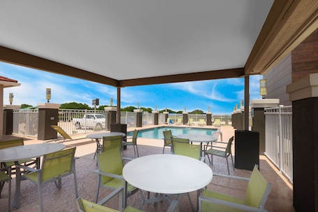 Una piscina al aire libre, sillones reclinables de piscina