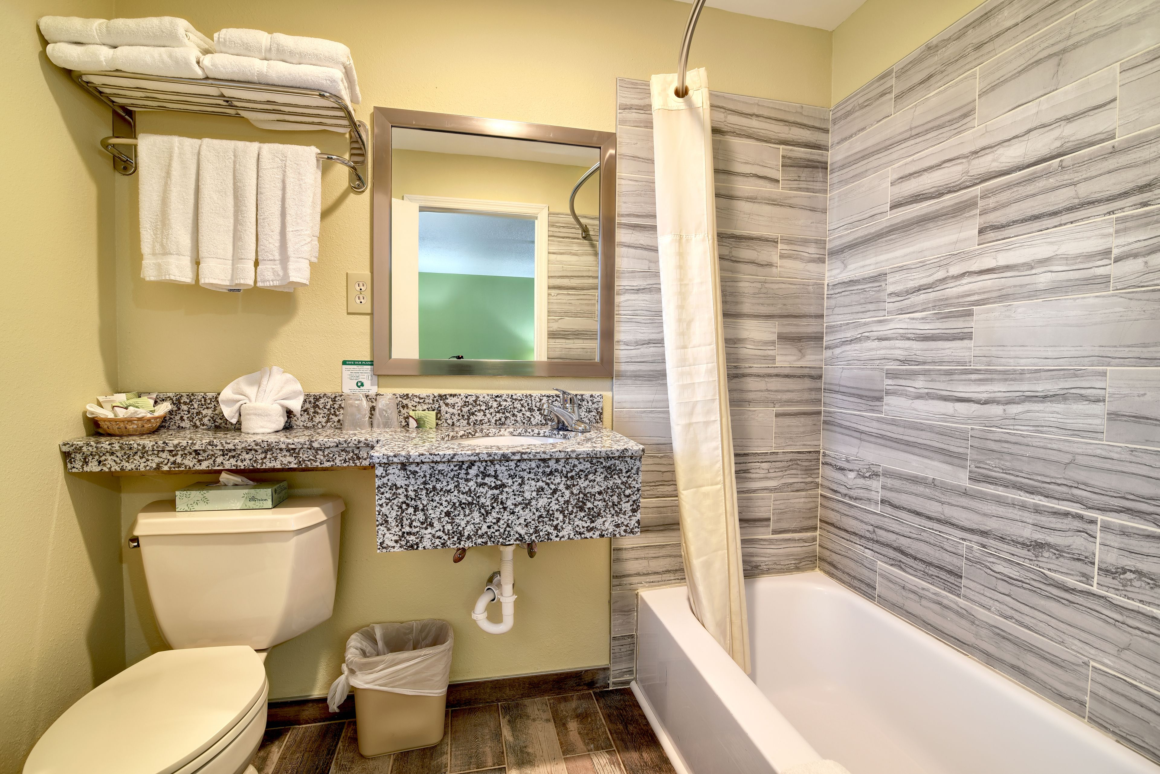 A bathroom with a toilet, sink, and bathtub.