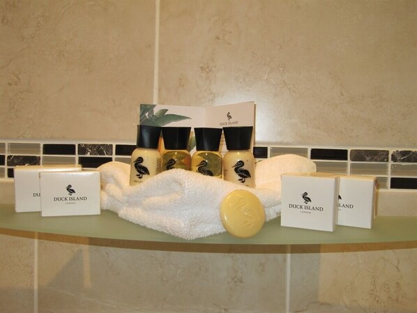 A display of Duck Island products including candles, a soap bar, and boxes on a bathroom counter. - The Shirley (Torquay)