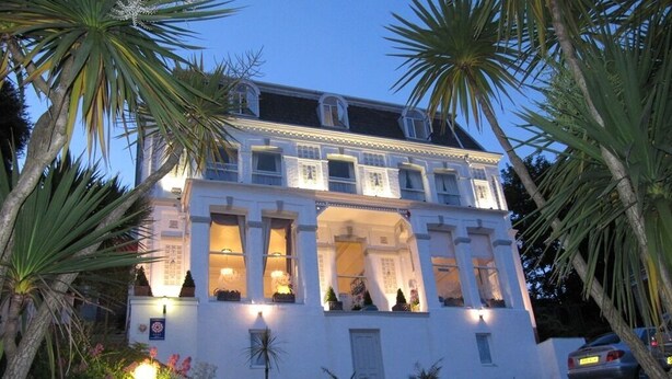 A two-story building with a symmetrical facade, large windows, and a central entrance. - The Shirley (Torquay)