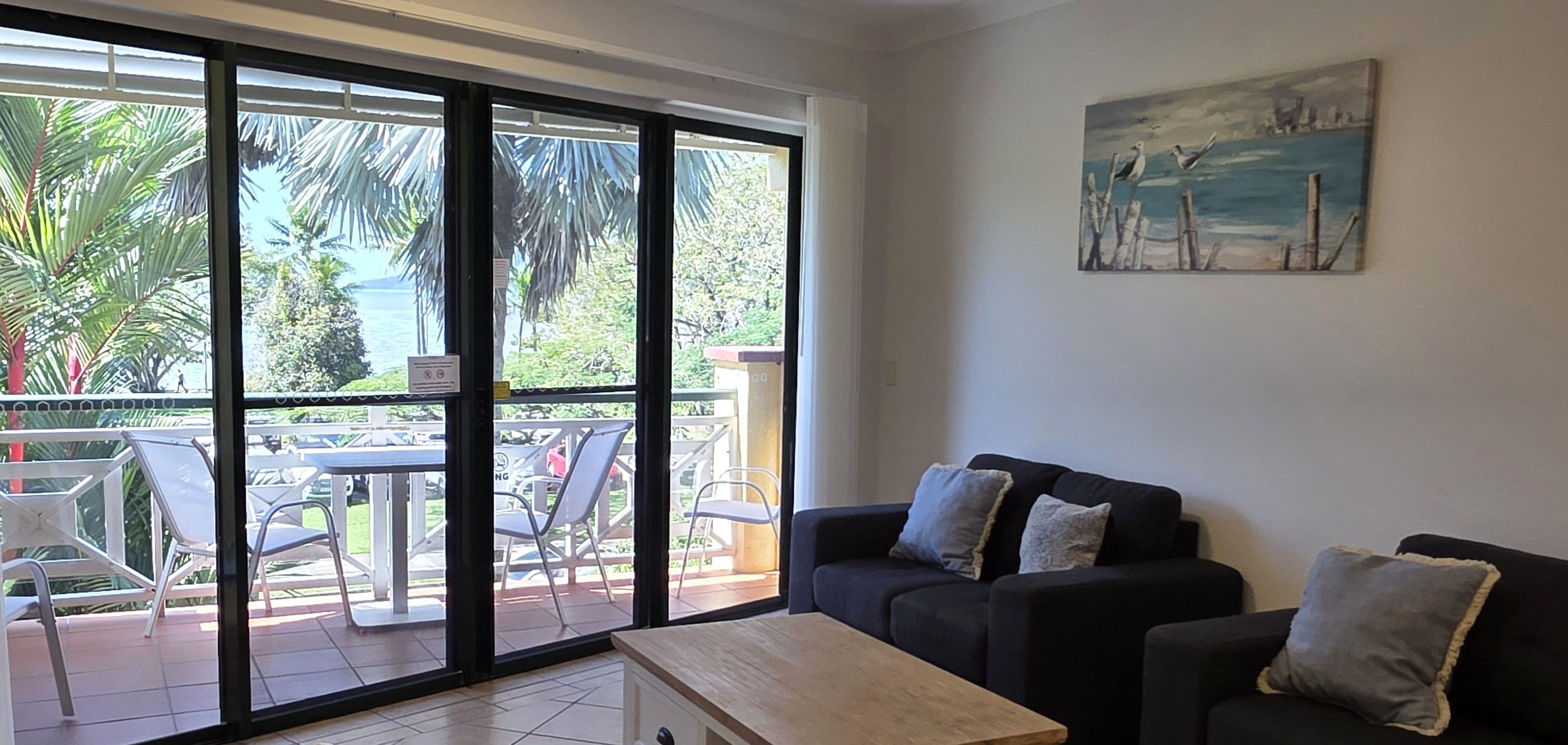 A living room with a sliding glass door leading to an outdoor patio area.