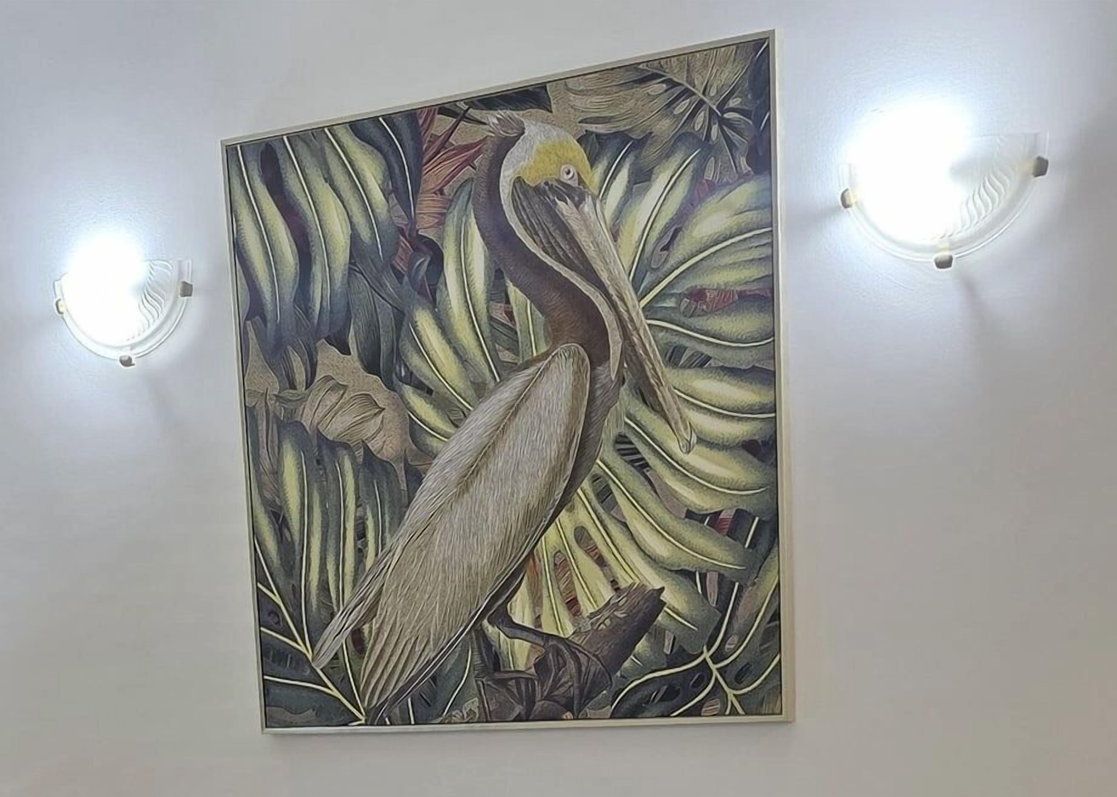 A wall-mounted painting of a bird among foliage, with two wall-mounted lights on either side.