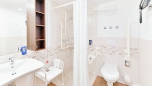 A modern bathroom with a shower, toilet, and sink. - Best Western Plus Hotel Papenburg (Papenburg)