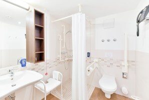 A modern bathroom with a shower, toilet, and sink. - Best Western Plus Hotel Papenburg (Papenburg)
