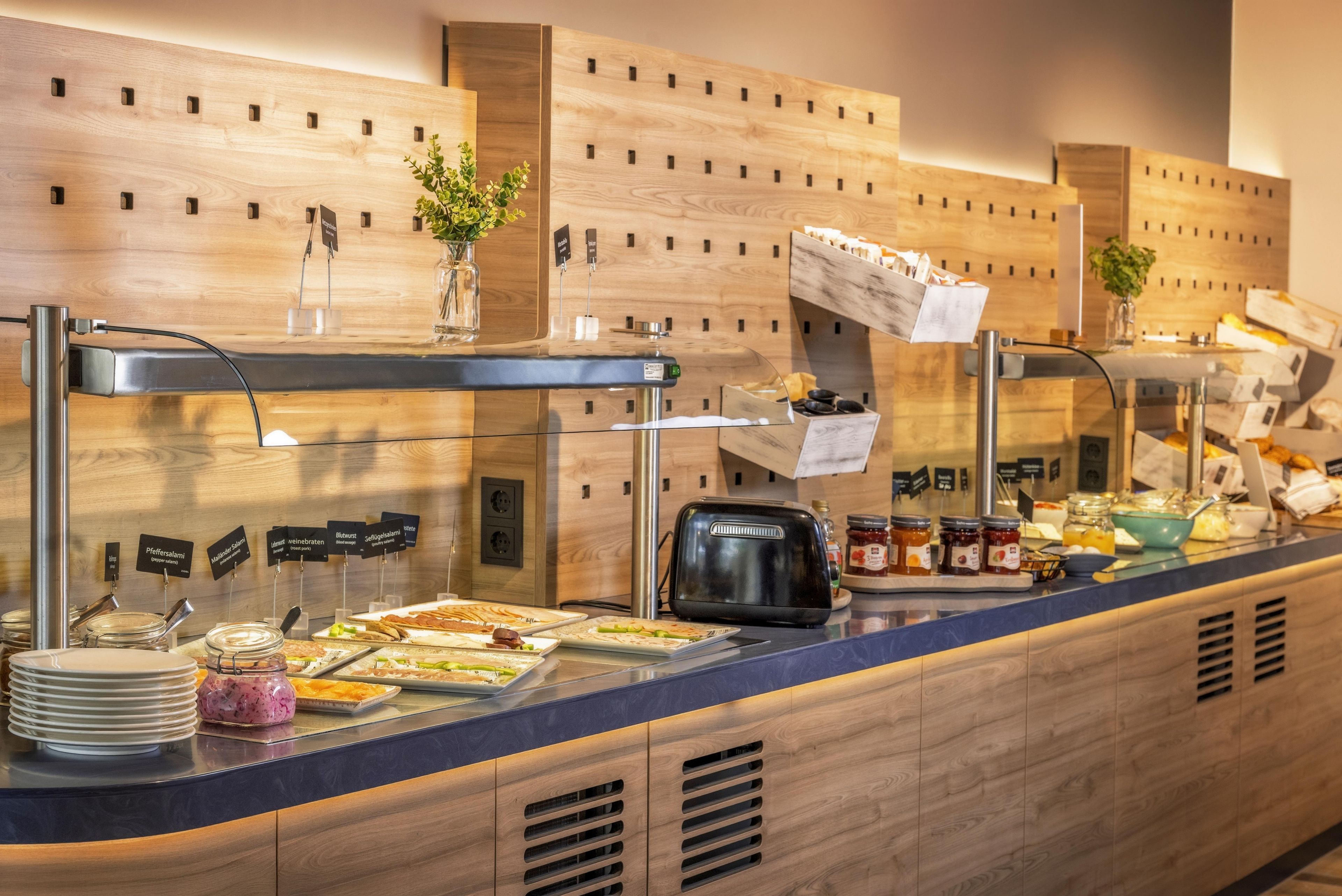 A buffet area with various food items and condiments.