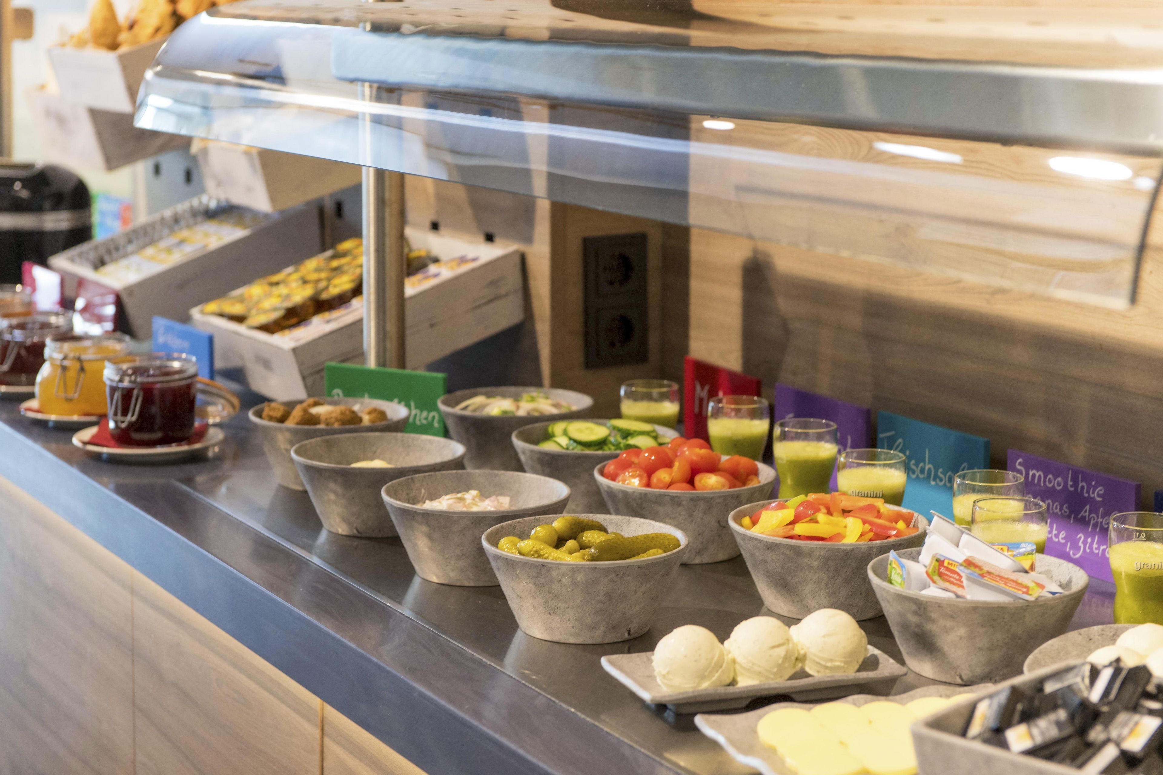 A buffet with various food items and drinks.