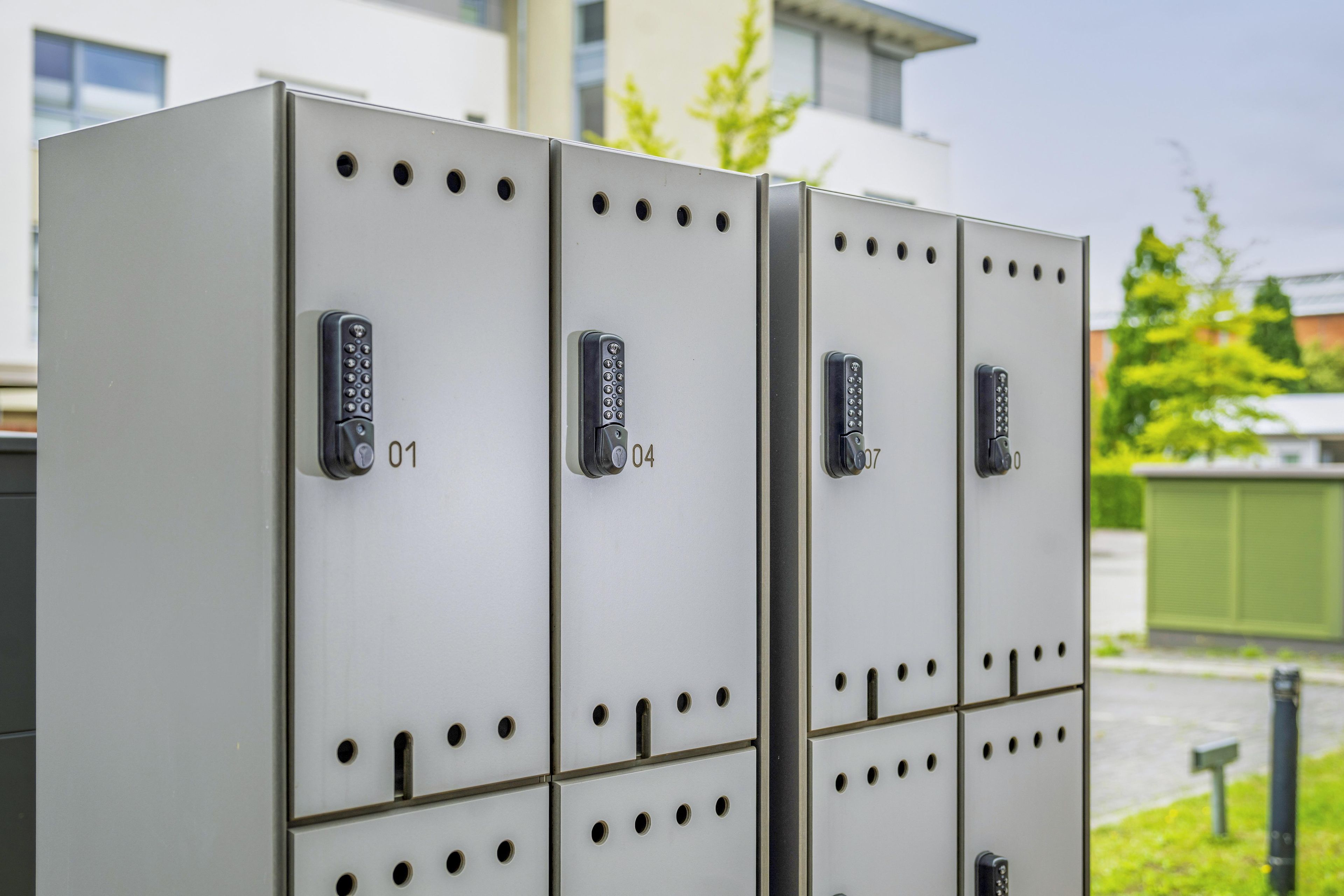 A row of metallic lockers with numbered locks, each featuring a keyhole and a numeric lock.
