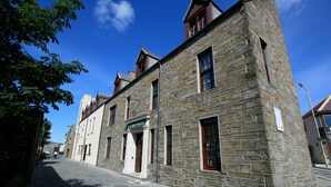 A stone building with a sign for the Albright Hotel.