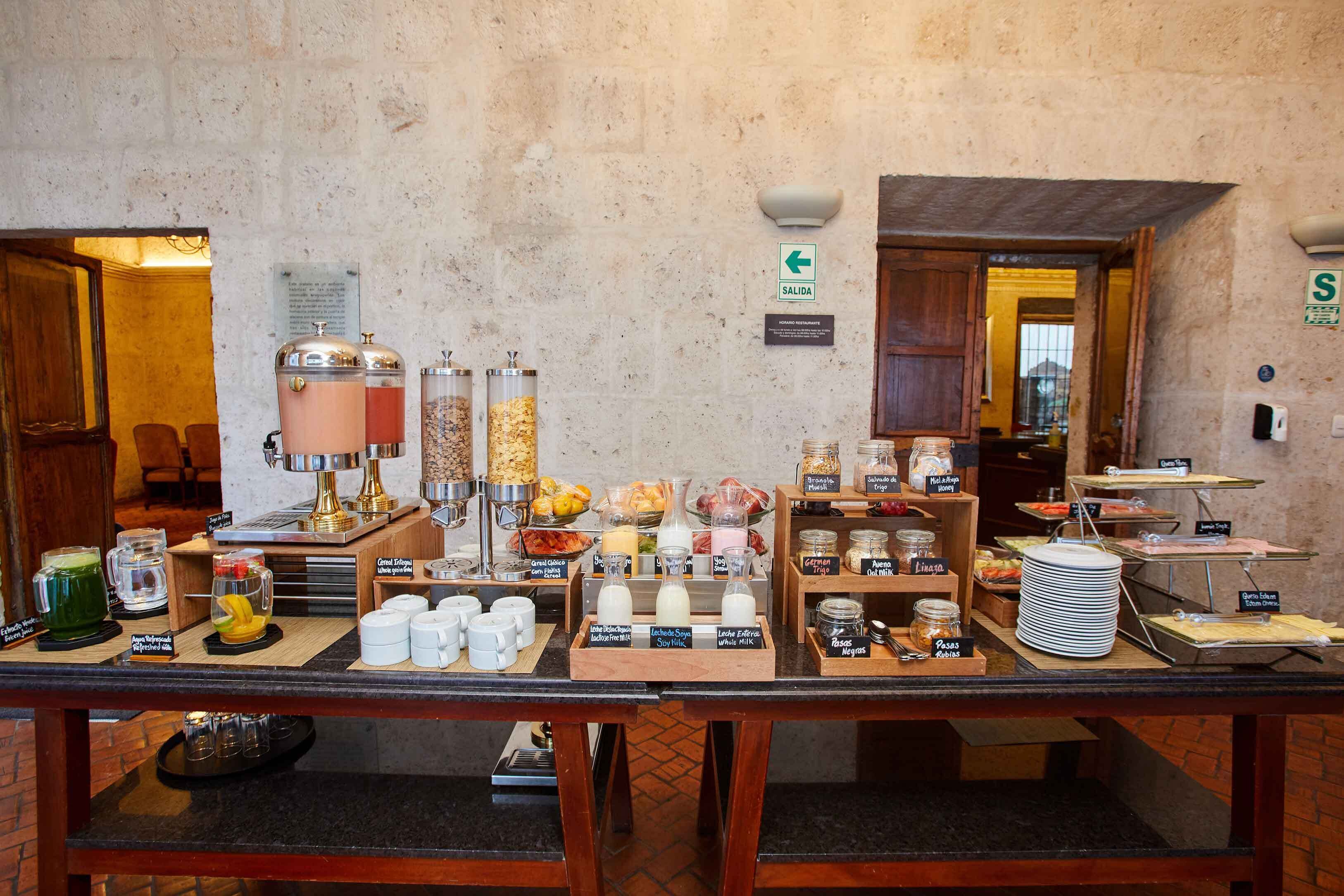 A breakfast buffet with various food items and beverages.